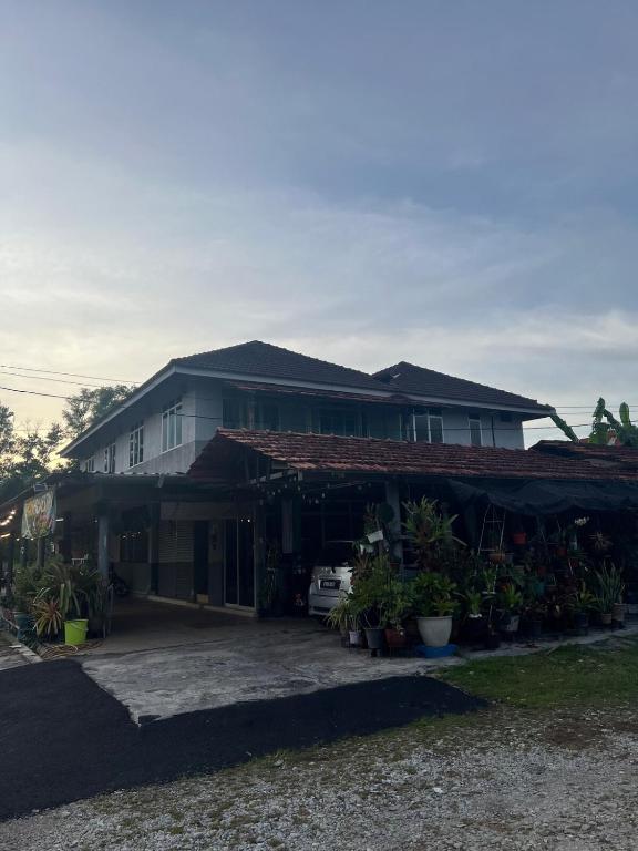 a house with a lot of plants in front of it at D'Huda Homestay in Sungai Petani