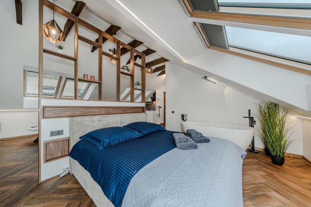 a bedroom with a large bed with blue pillows at Chamber Luxury House in Kaunas