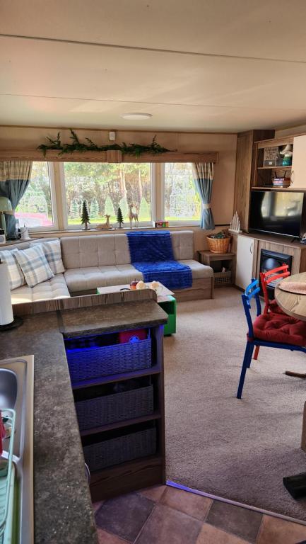 a living room with a couch and a table at Seton Sands Holiday Village GULLANE 5 in Longniddry