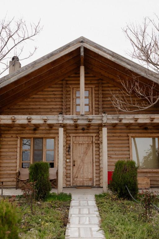 a wooden house with a door in front of it at Hyades Mountain Resort in Kato Trikala Korinthias