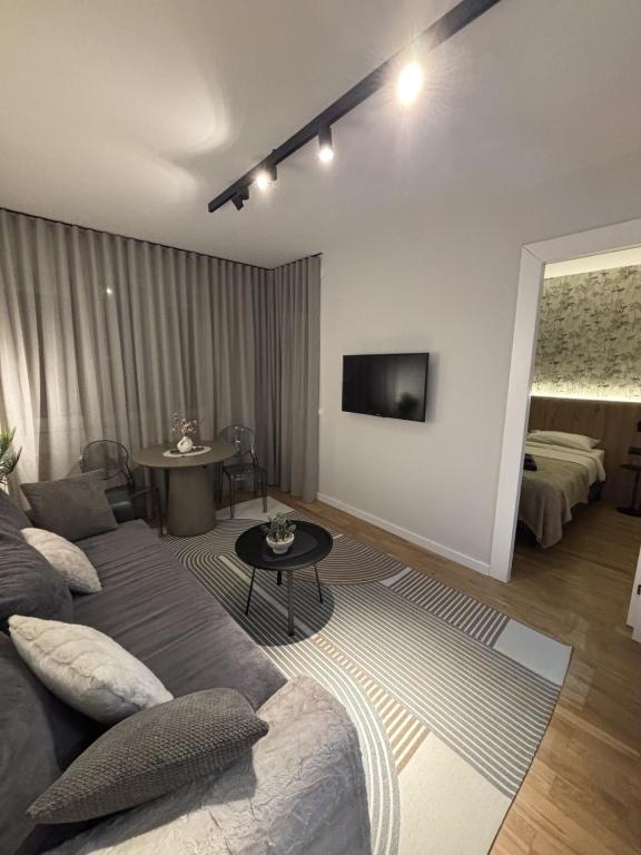 a living room with a couch and a table at Urban Nest Belgrade in Belgrade