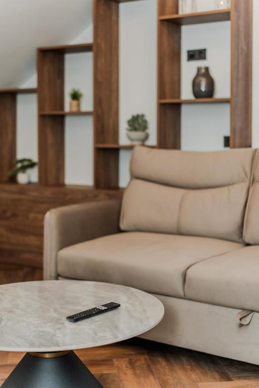 a living room with a couch and a table at Chamber Luxury House in Kaunas