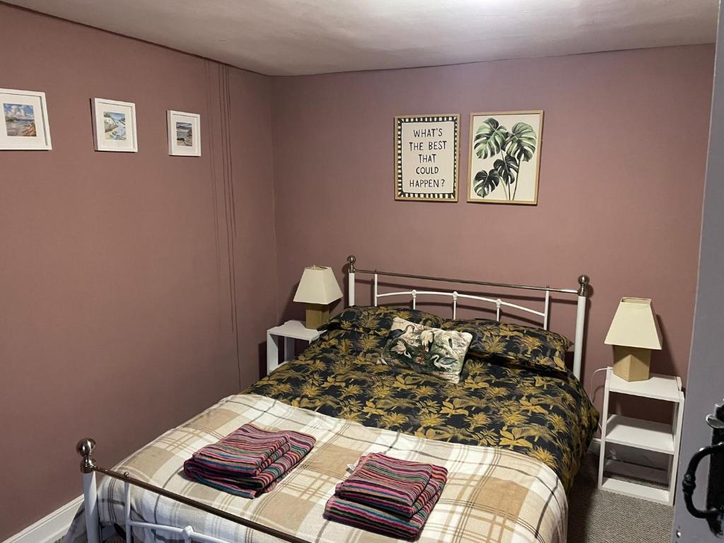 a bedroom with a bed and two lamps at Fox Haven in Bicester