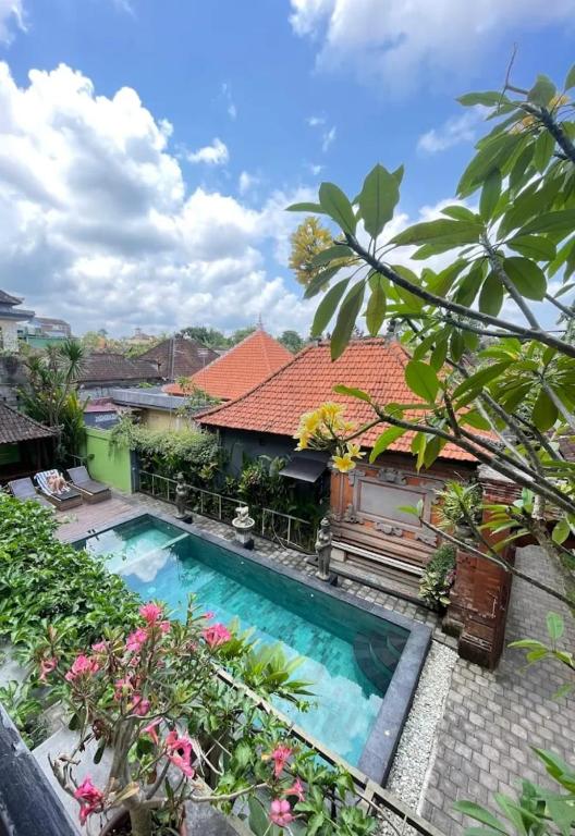a view of a swimming pool in front of a house at Buana Ubud Inn in Ubud