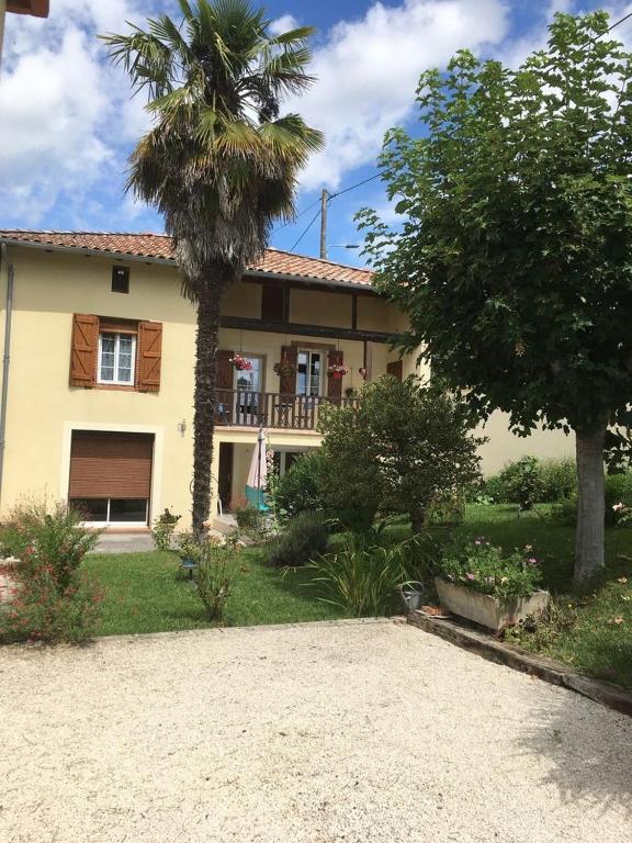 a house with a palm tree in front of it at La Maison d'Alice in Finhan