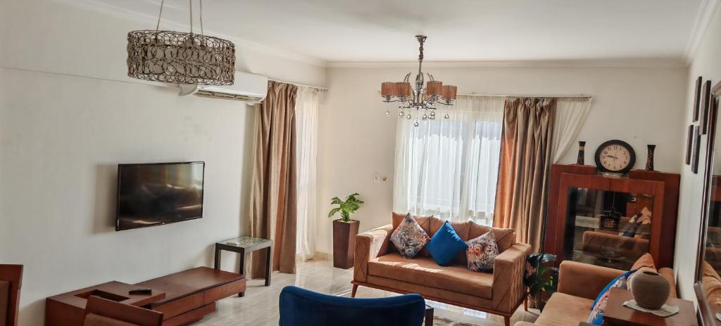a living room with a couch and a chair at Al Rehab city, Avenue Mall group129 bulding7 5th, CASA MIA in New cairo