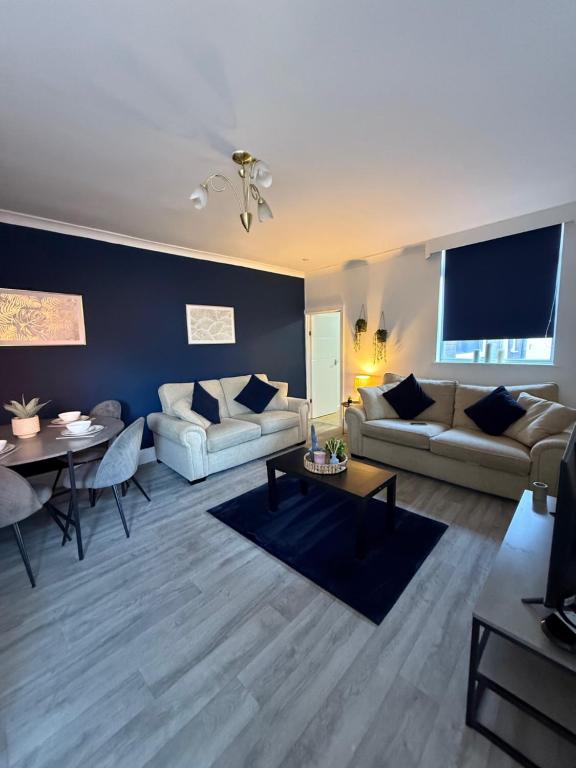 a living room with two couches and a table at Rochester House in Middlesbrough