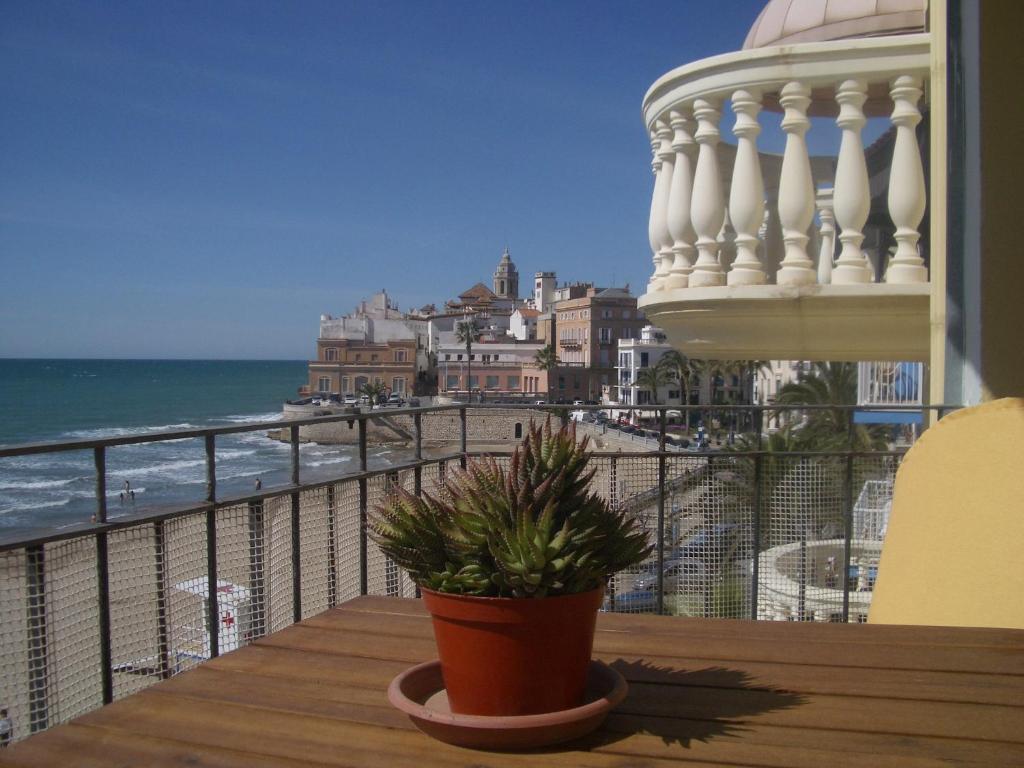 a potted plant on a balcony with a view of the ocean at Sitges Beach Panorama in Sitges