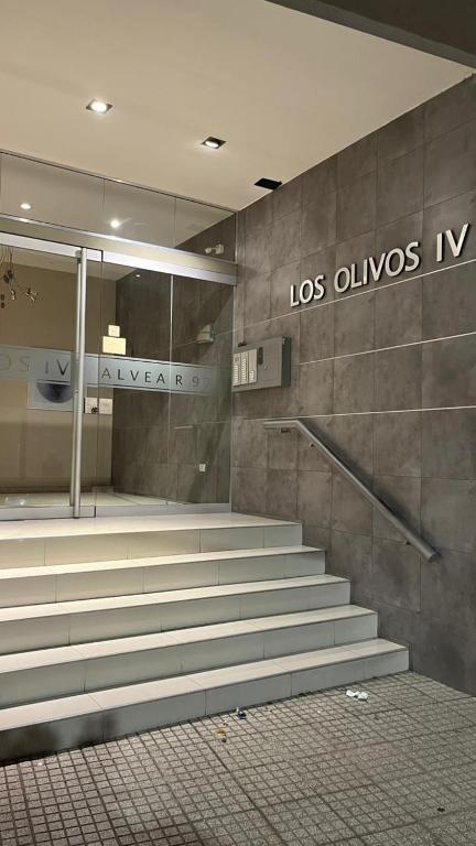 an empty lobby with stairs in a building at Departamento Orlando, zona centro in Villa Carlos Paz