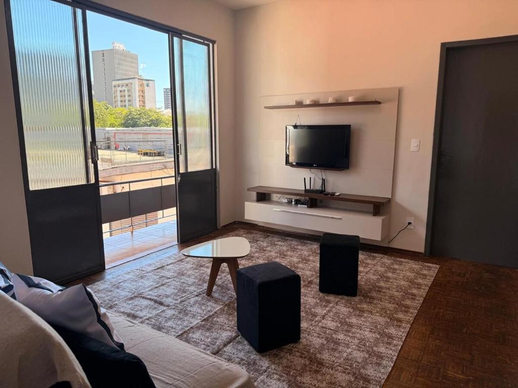 a living room with a flat screen tv and a couch at Casa do Mauro in Foz do Iguaçu