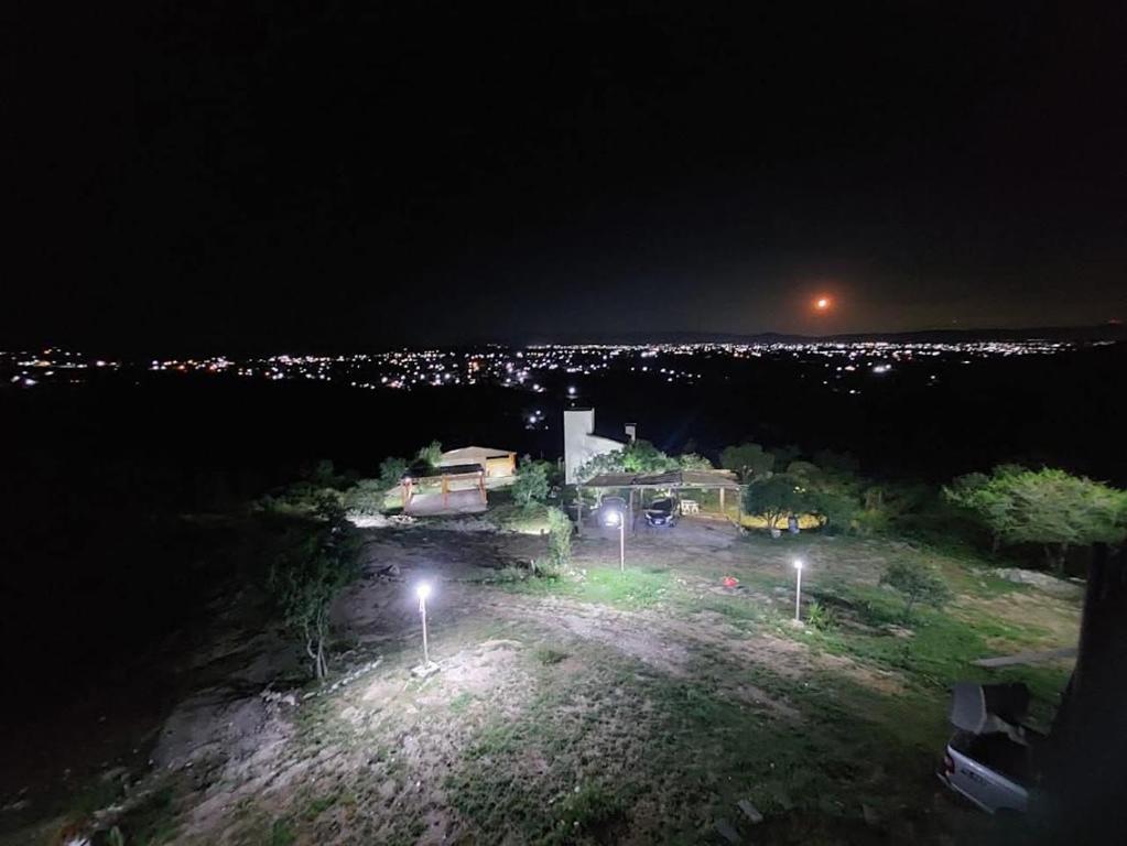 an aerial view of a house at night with lights at cabaña el mirador in Tanti