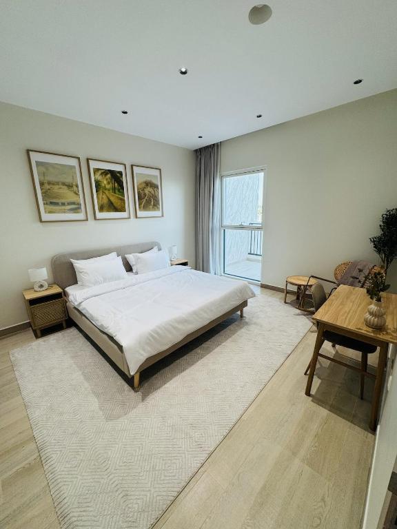 a bedroom with a large bed and a large window at Family-Friendly 2BR on Yas Playground access in Yas Island