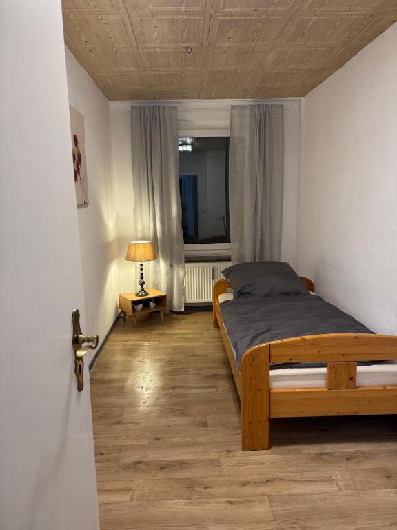 a bedroom with a wooden bed and a window at Dorfplatz in Klötze
