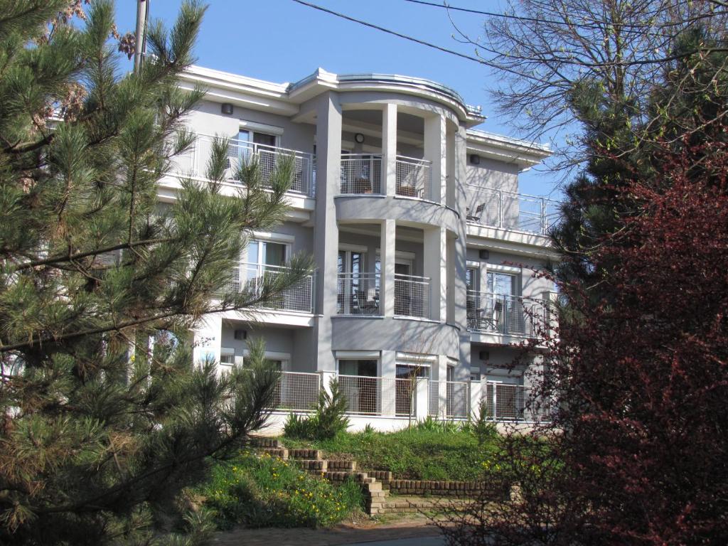 a large white building with a balcony on the front of it at Pansion Vila Vanda Vukovar in Vukovar