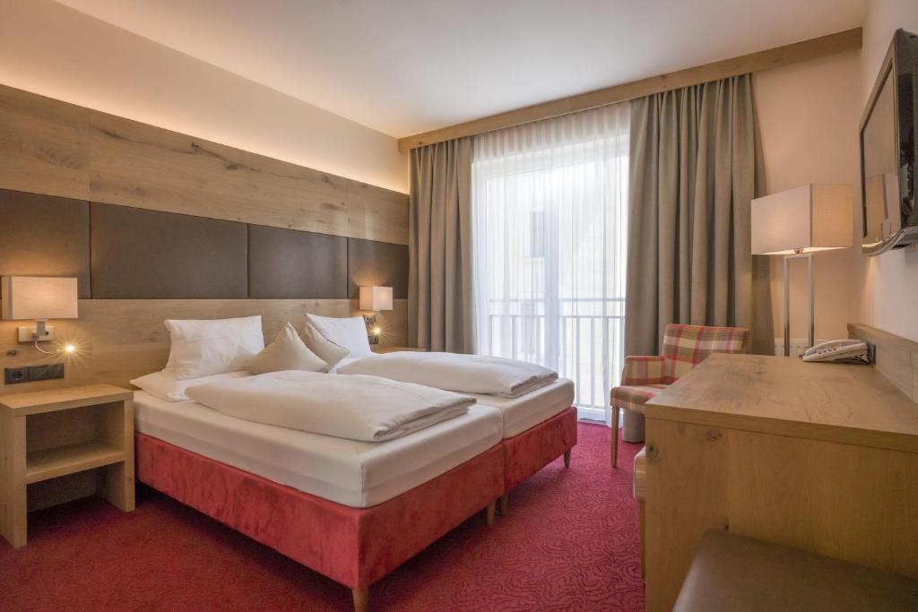 Postel nebo postele na pokoji v ubytování Hotel Andreas Hofer