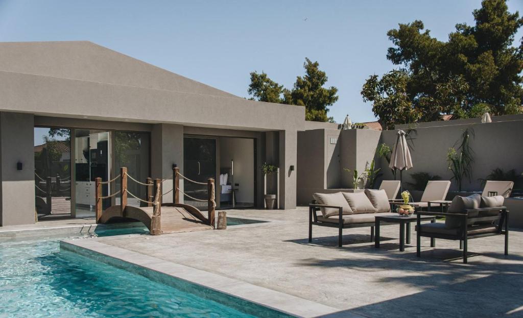 a patio with a swimming pool and a house at Mat Luxury Villa in Zakynthos