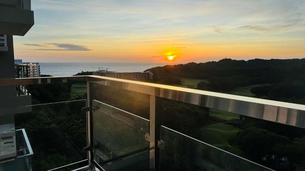 a view of the sunset from the balcony of a building at Ocean Verde Suite Boracay in Boracay