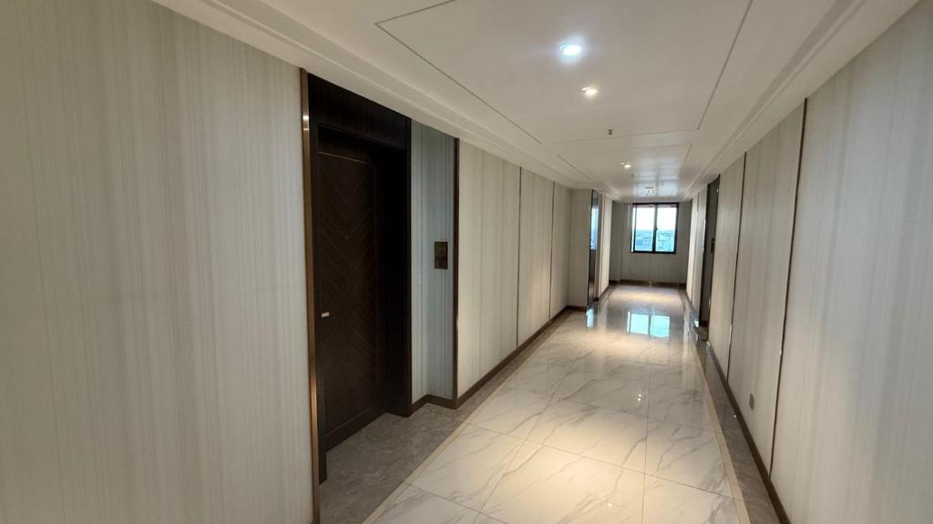 a hallway of a building with a door and a hallwayngth at NAGA Frontier Apartment in Vientiane