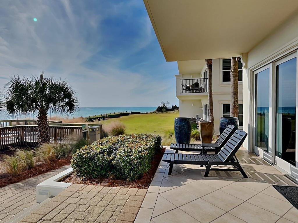 a bench sitting on a patio in front of a house at Adagio #105B in Santa Rosa Beach