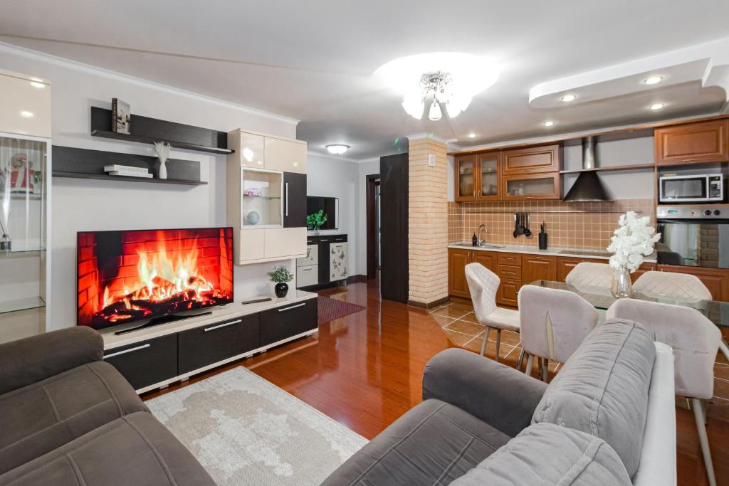 a living room with a couch and a fireplace at Просторная квартира рядом с набережной in Pavlodar