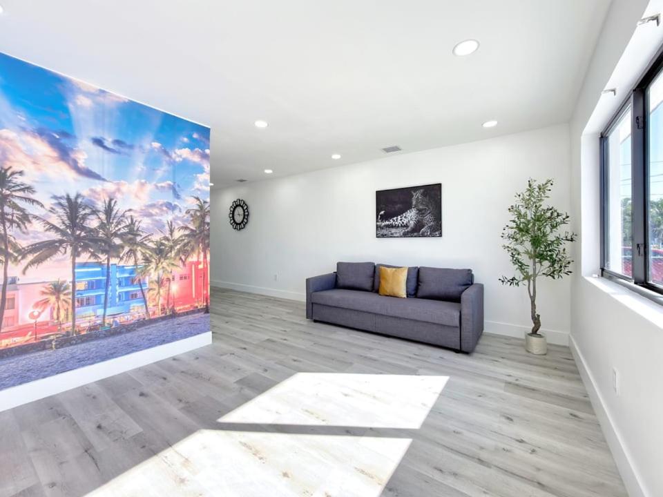 a living room with a couch and a large painting at Lux Miami Escape - Near Brickell- Free Parking in Miami