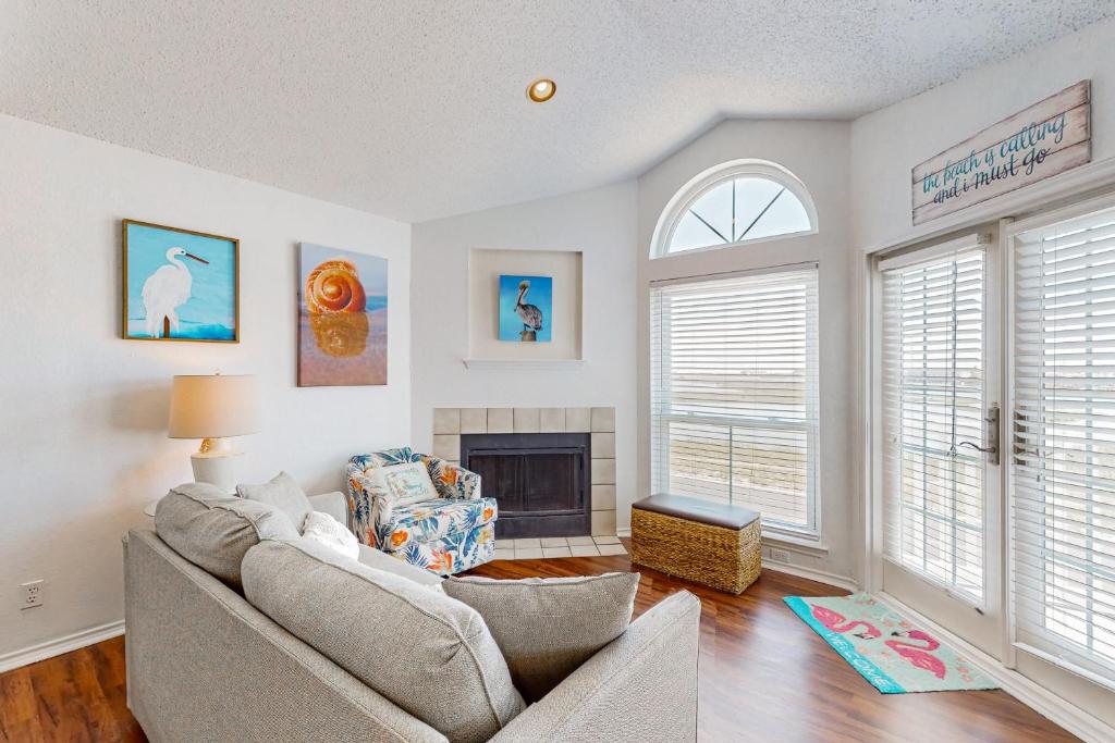a living room with a couch and a fireplace at Beach Club 323 in Padre Island