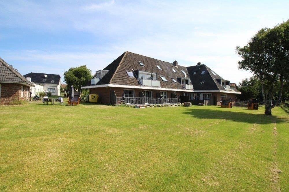 a large house with a large yard in front of it at Seaside-Amrum-5 in Norddorf