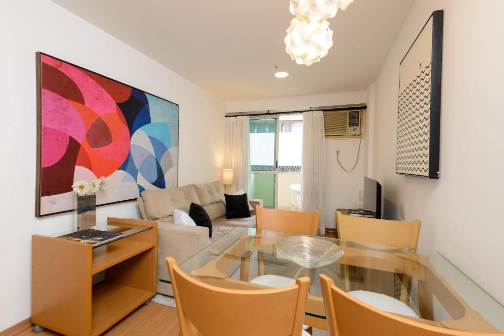 a living room with a glass table and chairs at Flat c/ Limpeza Diária e Estacionamento - LB507 in Rio de Janeiro