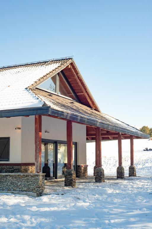 a building in the snow with snow at Planinska kuća Ema in Kupres
