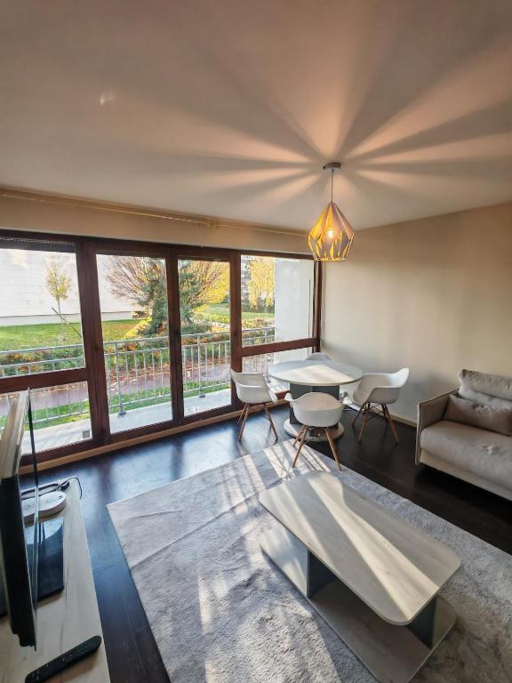 a living room with a table and a couch at La Fresque in Vélizy-Villacoublay
