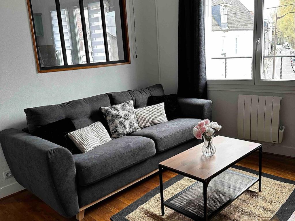 a living room with a couch and a coffee table at 2-room apartment near Marais and CV in Bourges