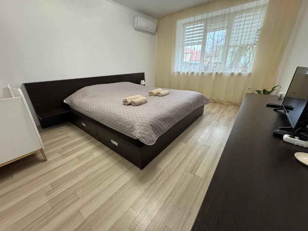 a bedroom with a bed with two towels on it at Veronika Apartments in Berehove