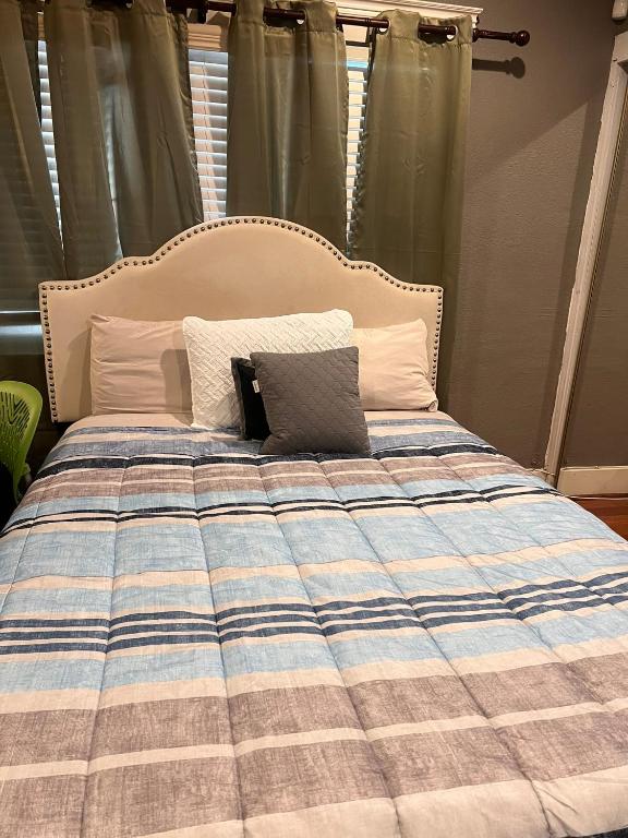 a bed with a laptop sitting on top of it at Room in Riverside in Riverside