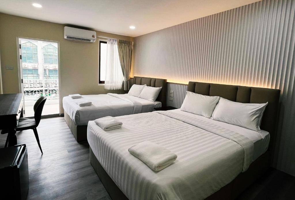 Postel nebo postele na pokoji v ubytování Excel Hotel Bangkok former Sri Krungthep Hotel