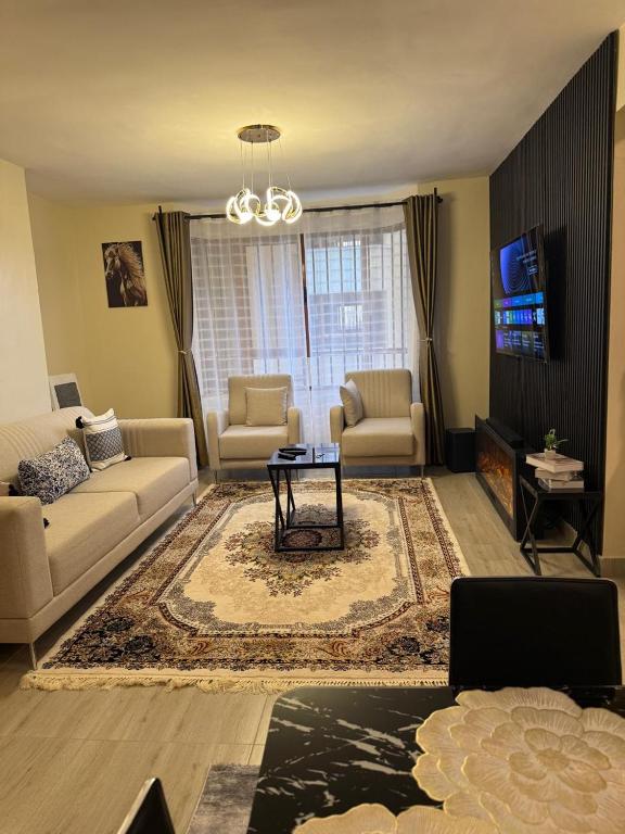 a living room with a couch and a table at LionsGate Homes in Nakuru
