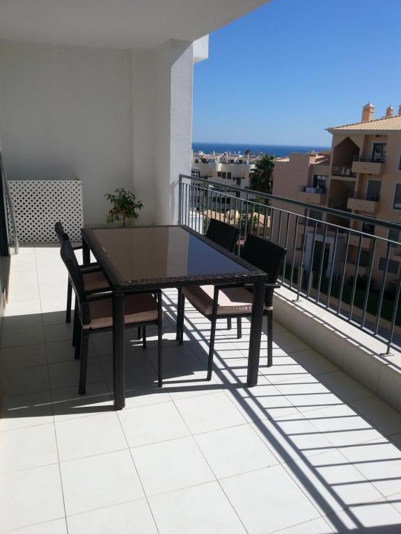 a black table and chairs on a balcony at Apartment with terrace Albufeira Olhos de Água in Albufeira