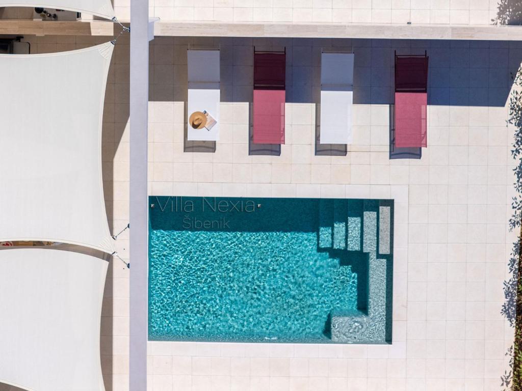 a lego swimming pool with a person laying in a pool at Villa Nexia Šibenik in Šibenik