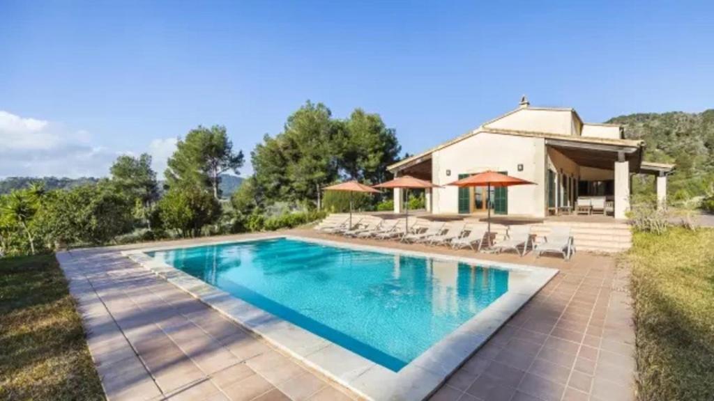 a swimming pool in front of a house at Son Aladern in Islas Baleares