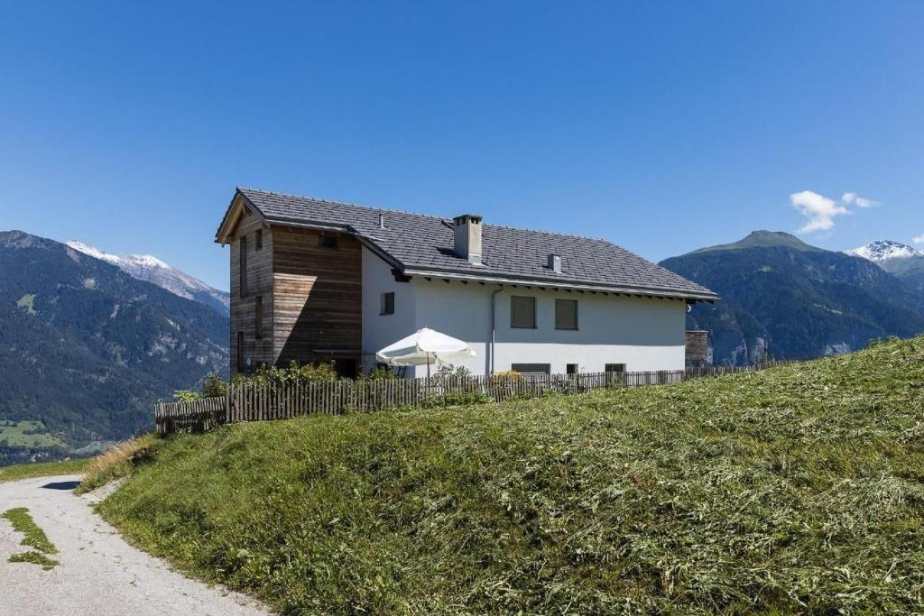 a house on top of a hill with a dirt road at Hof Quadra in Flerden