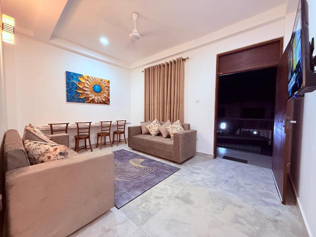 a living room with a couch and a table at Blooming Residences by Gold Mark Property Consultants in Nugegoda