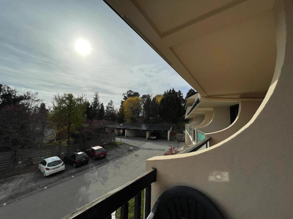 a balcony with a view of a parking lot at Studio accueillant avec vue montagne à Font-Romeu in Font-Romeu