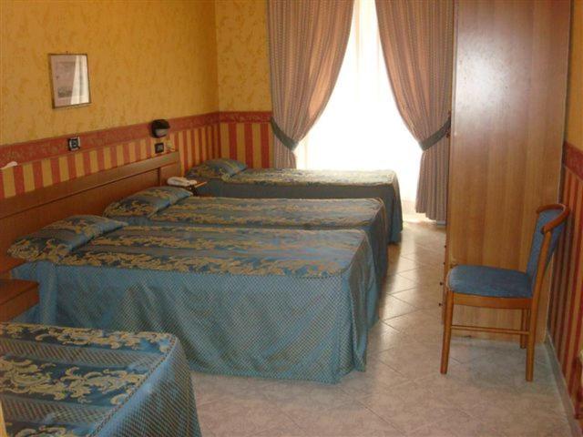Postel nebo postele na pokoji v ubytování Hotel Demetra Capitolina