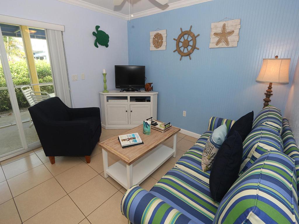 a living room with a couch and a table at Silver Sands #232 in Longboat Key