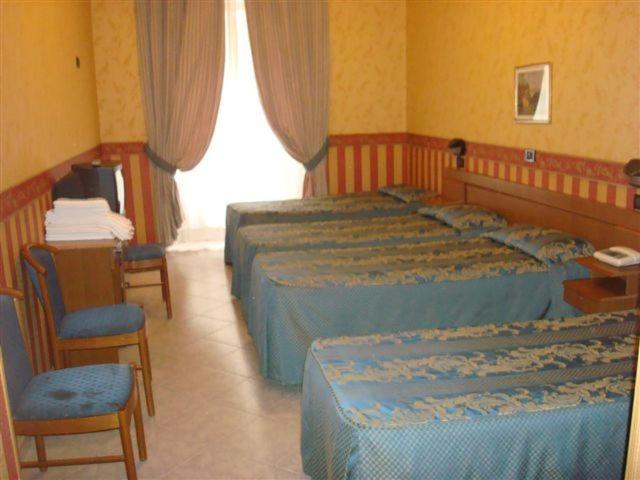 Postel nebo postele na pokoji v ubytování Hotel Demetra Capitolina