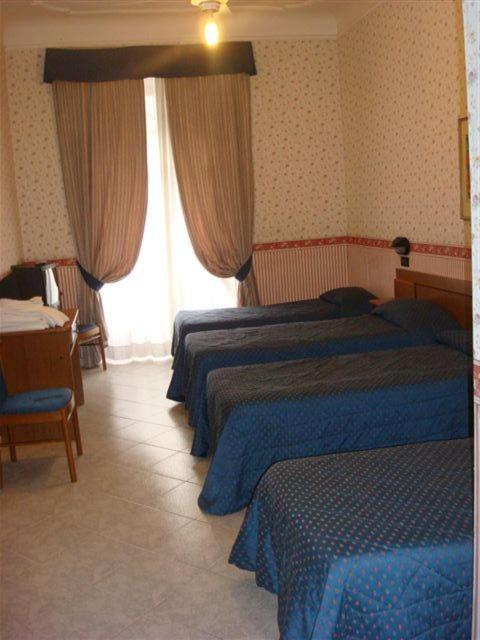 Postel nebo postele na pokoji v ubytování Hotel Demetra Capitolina