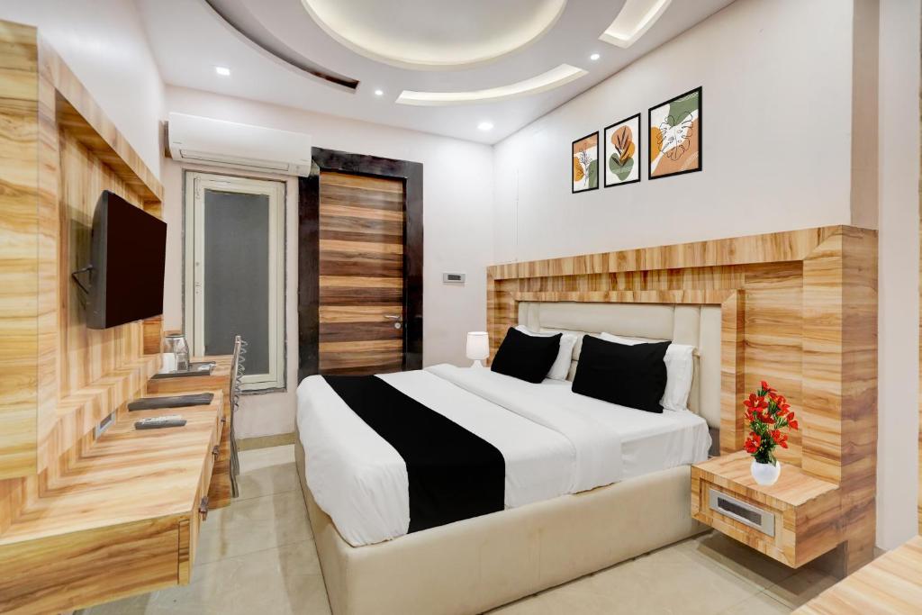 a bedroom with a bed and a flat screen tv at Townhouse Oak CSJMU Kanpur Formerly Shree Dev Villa in Kaliānpur
