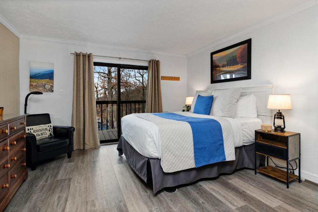 a bedroom with a large bed and a window at Timbers Studio 14 with Wintergreen Advantage in Wintergreen