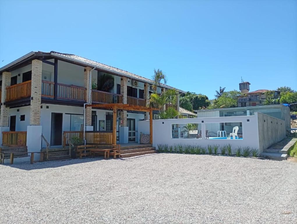 a house on the beach with a yard at Pousada Kauai in Imbituba