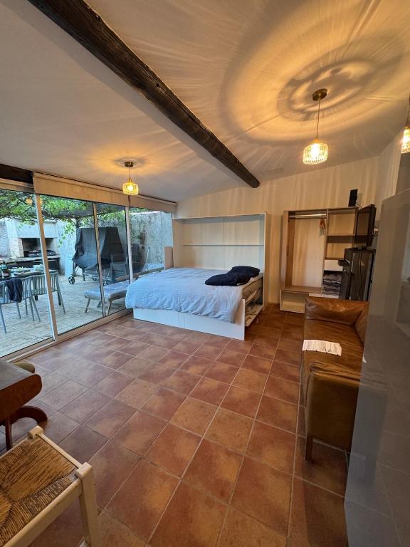 a bedroom with a bed and a living room at Studio with pool and quiet, non-shared garden, 1 lit double in Gardanne