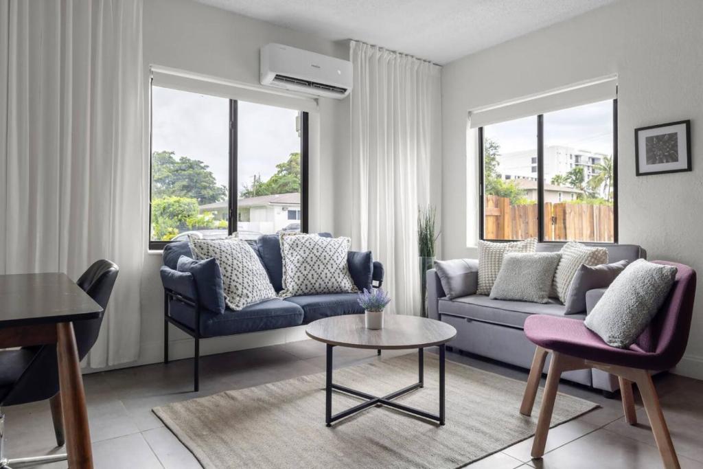 a living room with two couches and a table at Unit 1 Cozy 1BR Apt with Parking in Miami
